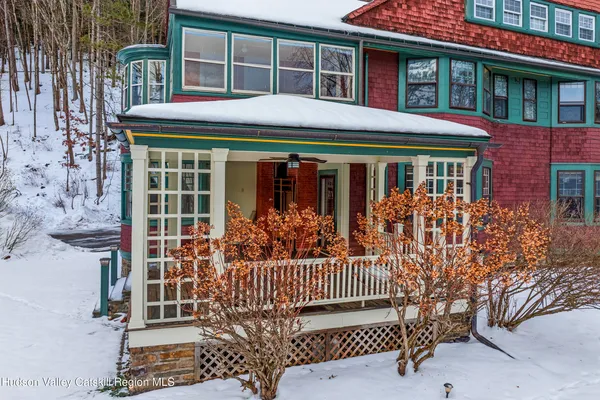 a living room with furniture a fireplace and a chandelier