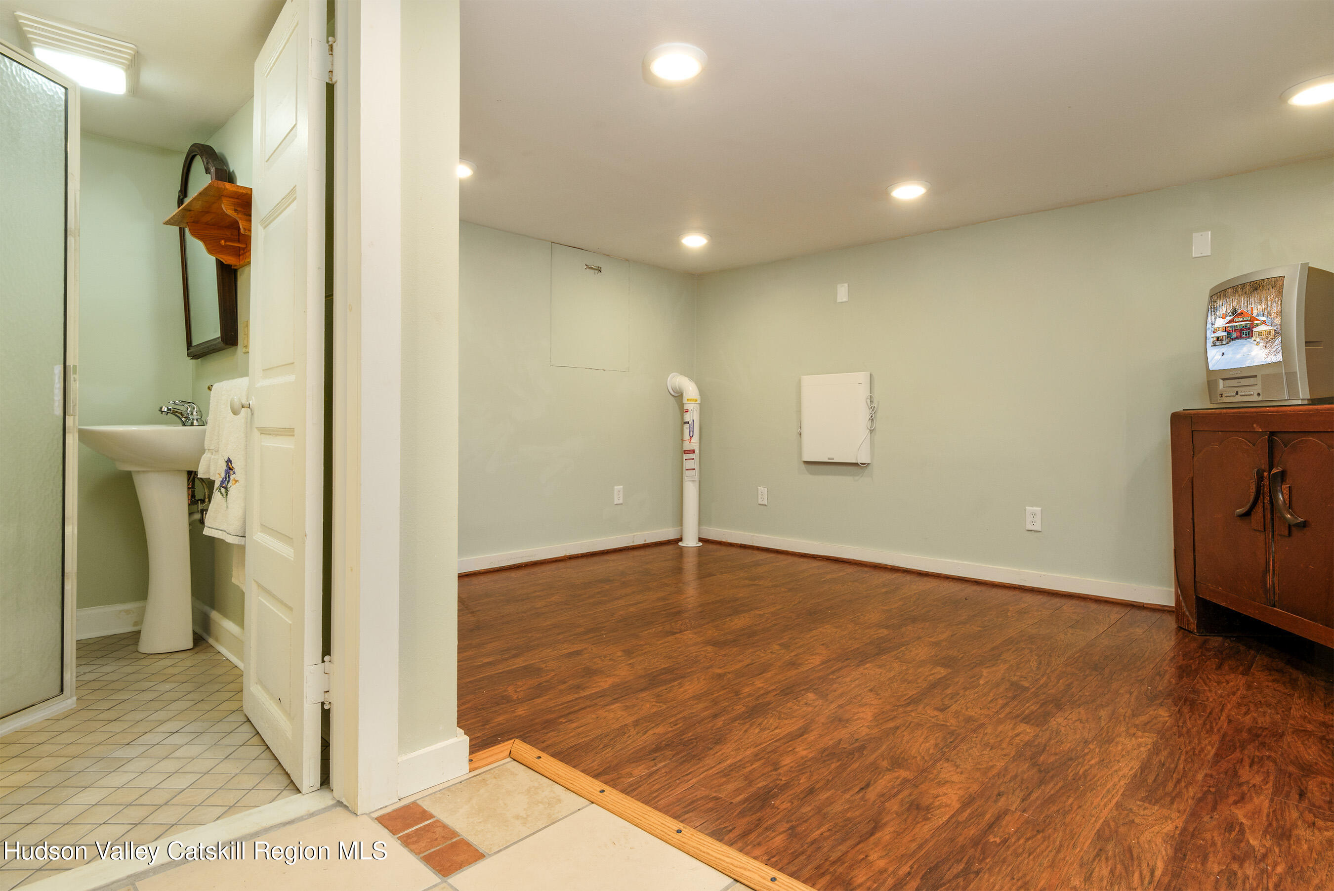 6 Westridge Road Cooperstown, NY 13326 - Photo 90 of 109 a view of a livingroom with a fireplace and wooden floor