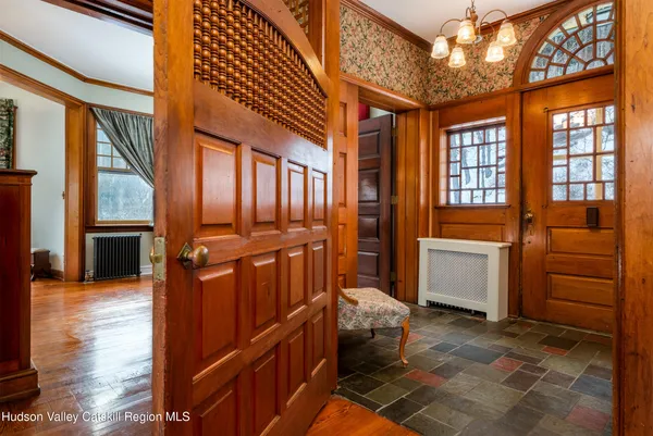 a view of a livingroom with furniture a dinning room and wooden floor
