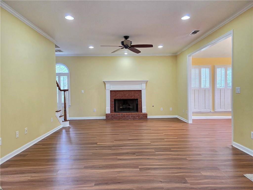 3715 Ridgeside Court Suwanee, GA 30024 - Photo 12 of 44 a view of an empty room with a fireplace and a window