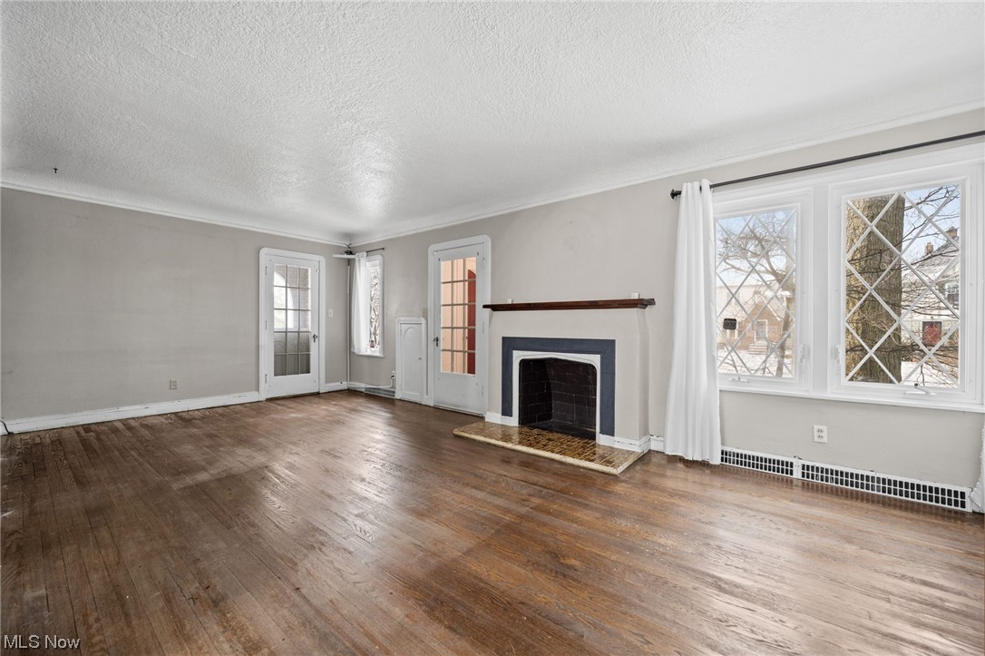 1203 Plainfield Road Cleveland, OH 44121 - Photo 5 of 35 Living room with hardwood floor and fireplace