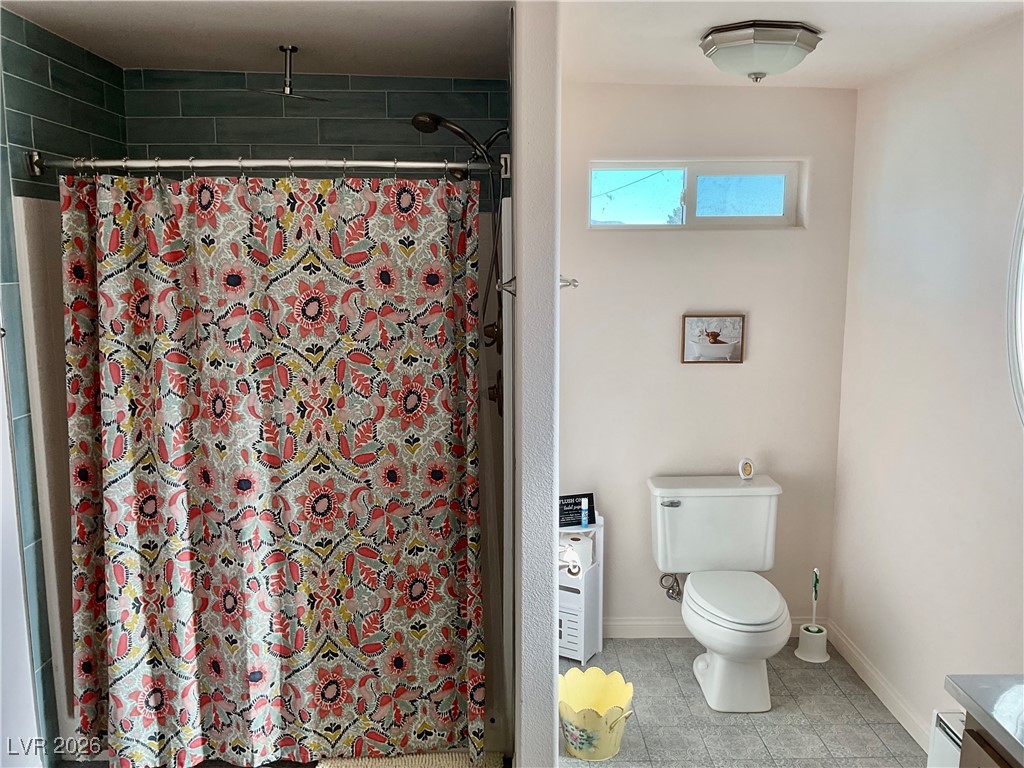 5261 East Kellogg Road Pahrump, NV 89061 - Photo 16 of 28 3/4 Bath off the laundry room with access to the covered patio.