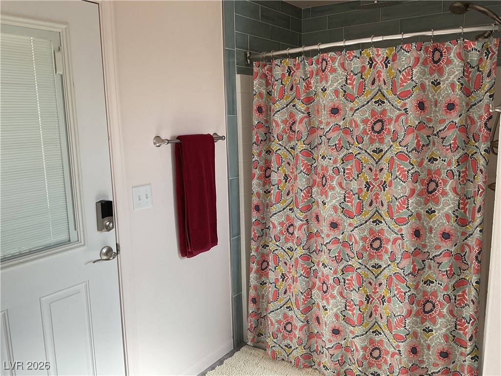 5261 East Kellogg Road Pahrump, NV 89061 - Photo 17 of 28 3/4 Bath off the laundry room with access to the covered patio.