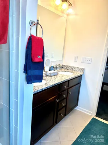 a bathroom with a sink vanity and a mirror