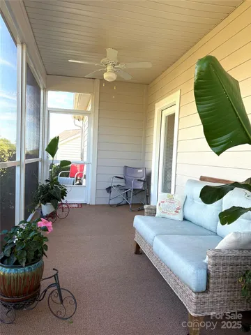a living room with furniture and flowers