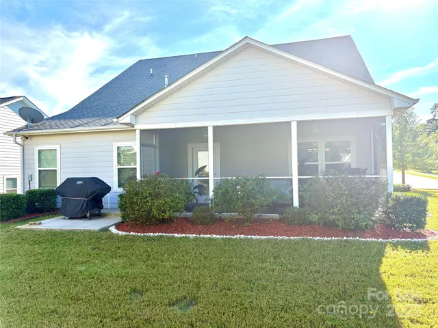 a front view of house with yard and outdoor seating