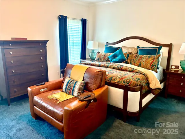 a bedroom with a bed couch and a dresser