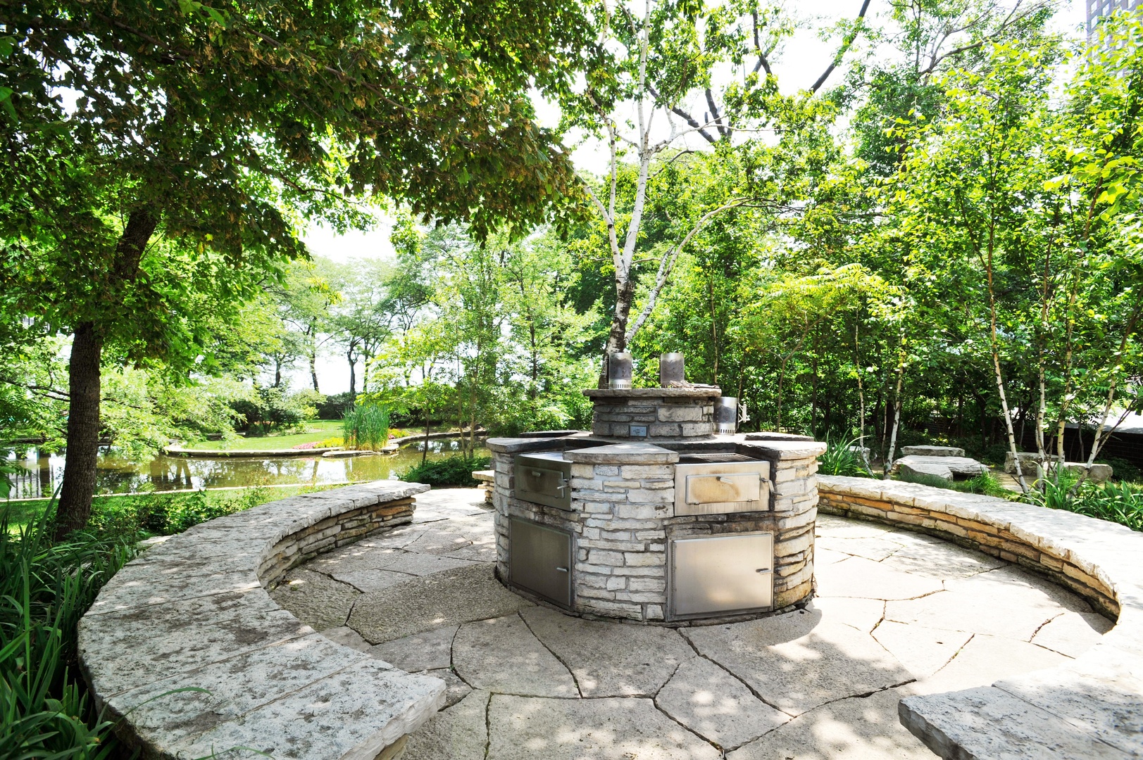 505 North Lake Shore Drive, Unit 1518 Chicago, IL 60611 - Photo 22 of 28 a view of a patio with table and chairs potted plants and large tree