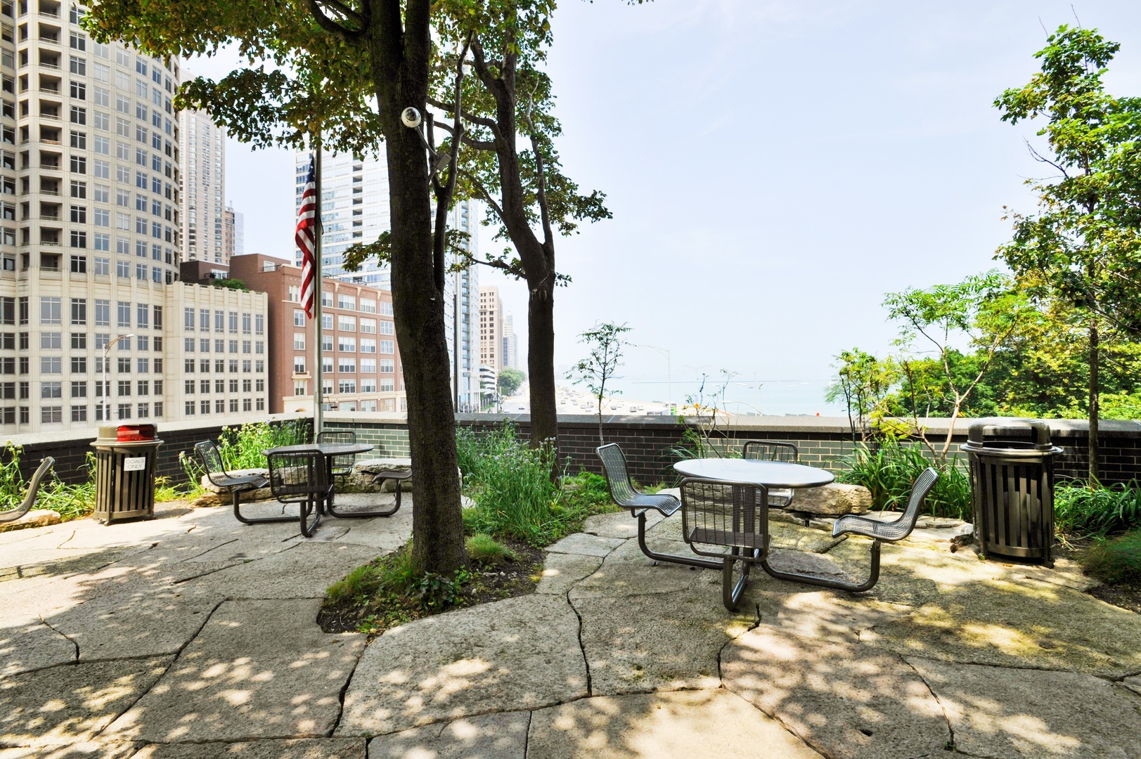 505 North Lake Shore Drive, Unit 1518 Chicago, IL 60611 - Photo 23 of 28 a view of a patio with table and chairs potted plants and palm tree