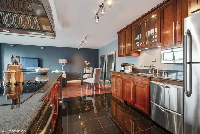 a kitchen with stainless steel appliances granite countertop a sink and cabinets