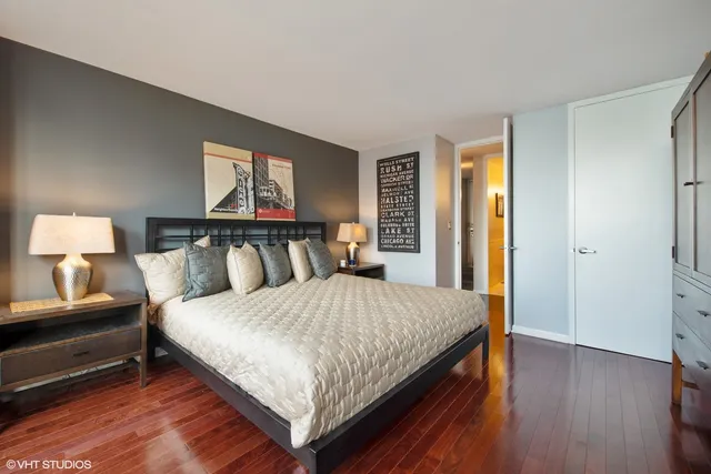 a bedroom with a bed and wooden floor