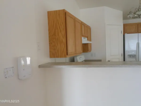 a view of a small space with wooden floor and a window