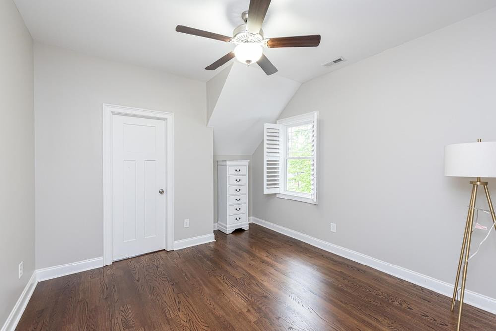 714 Edmund Street Raleigh, NC 27604 - Photo 19 of 30 Bedroom 3 with ceiling fan, hardwood floors, and walk-in closet.