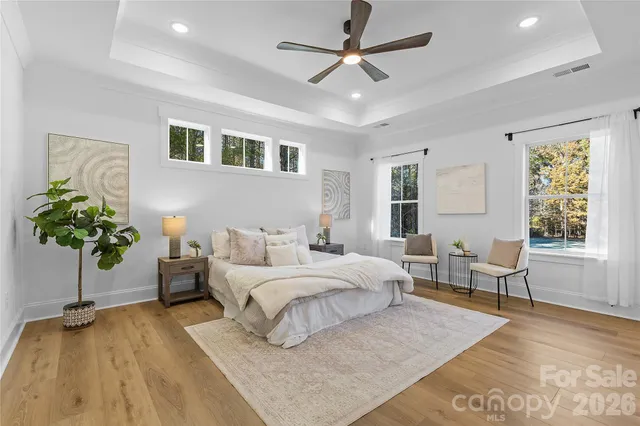 a bedroom with a large bed and paintings on the wall