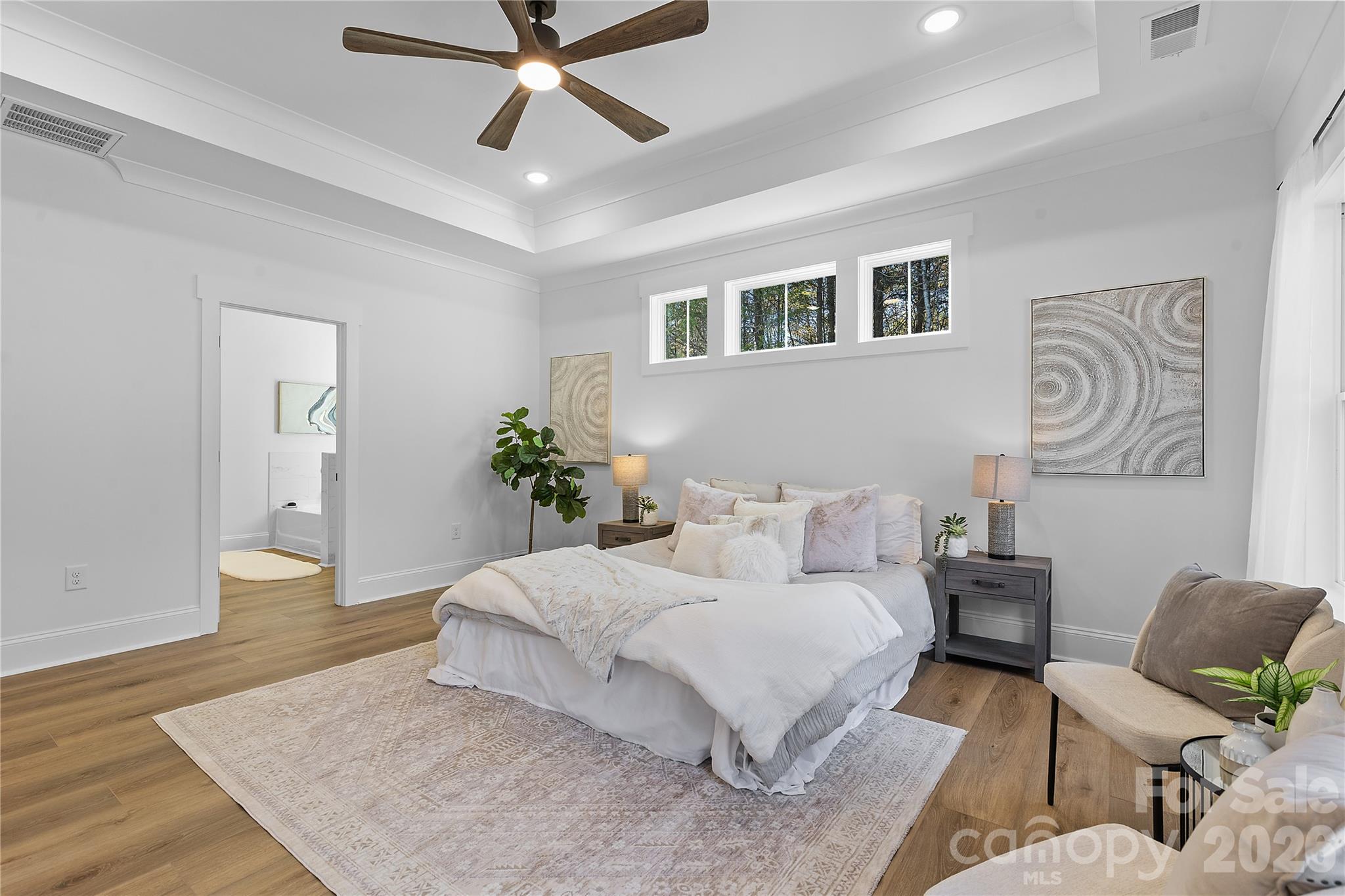 9729 Flowes Store Road Midland, NC 28107 - Photo 20 of 29 a bedroom with a large bed and paintings on the wall