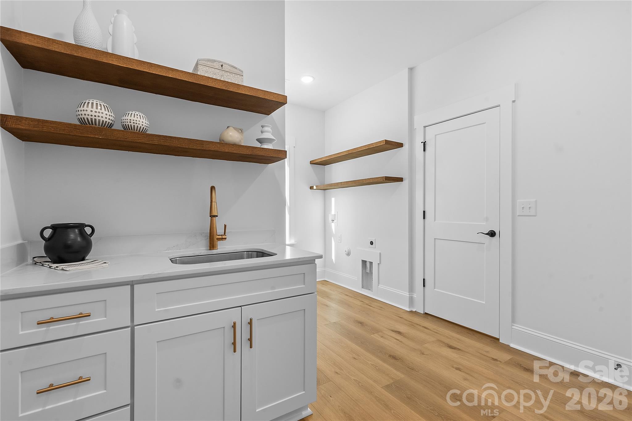 9729 Flowes Store Road Midland, NC 28107 - Photo 23 of 29 a kitchen with a cabinets and a wooden floor