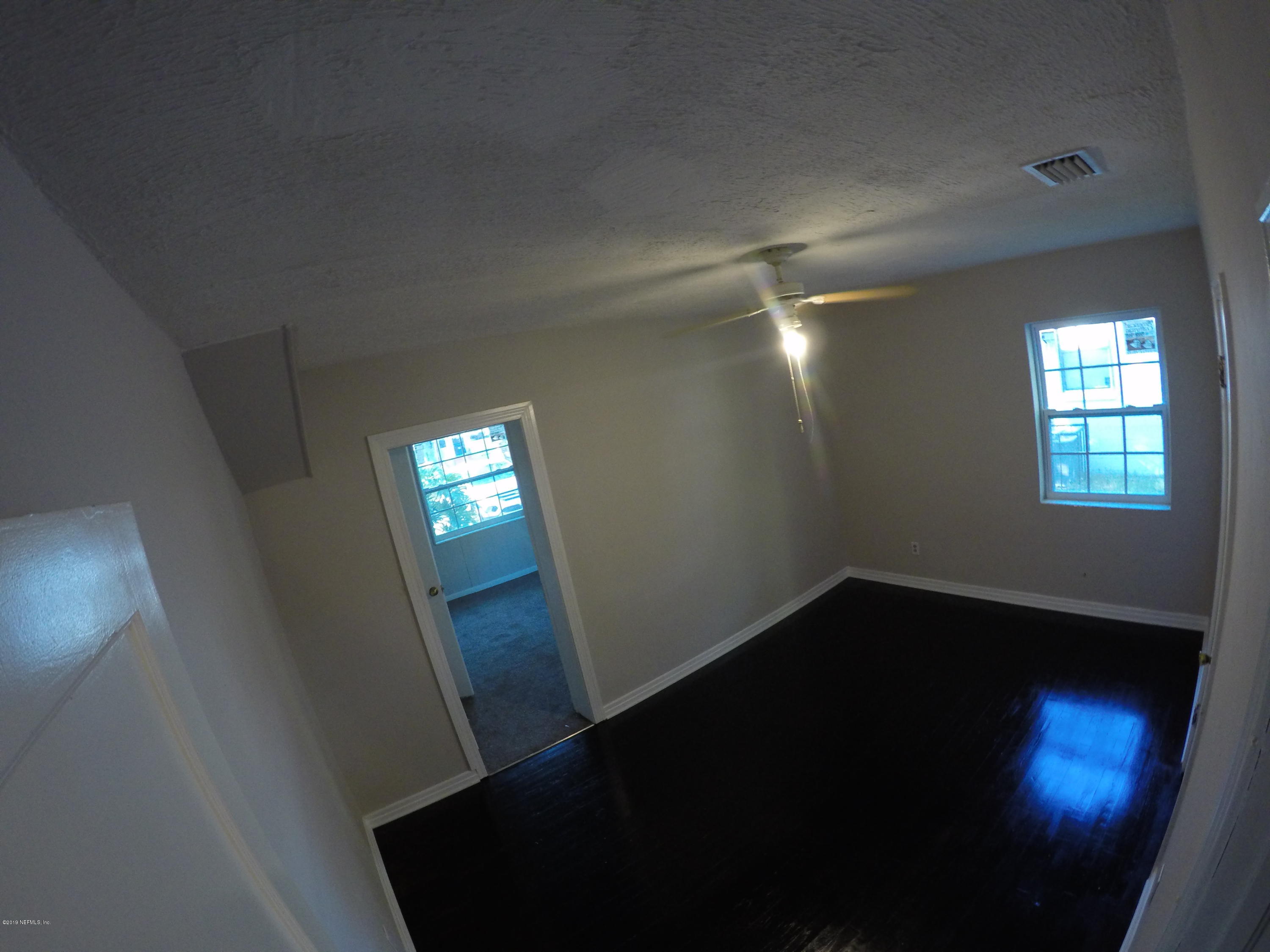 1043 Seba Street Jacksonville, FL 32205 - Photo 5 of 5 an empty room with wooden floor and windows