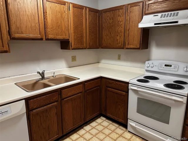 a kitchen with a sink cabinets and appliances