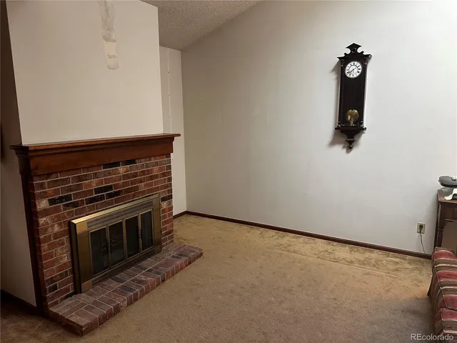 an empty room with a fireplace
