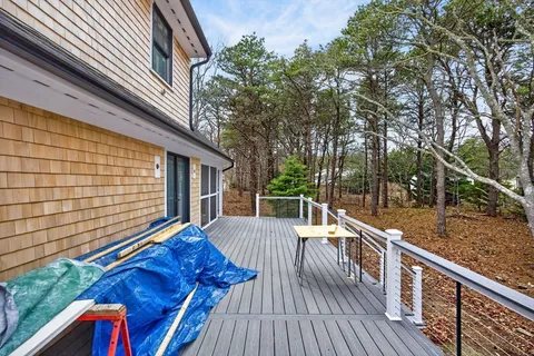 a front view of a house with a yard and wooden fence