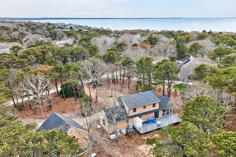 an aerial view of house with yard and mountain in the background