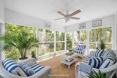 a living room with furniture a table and a large window