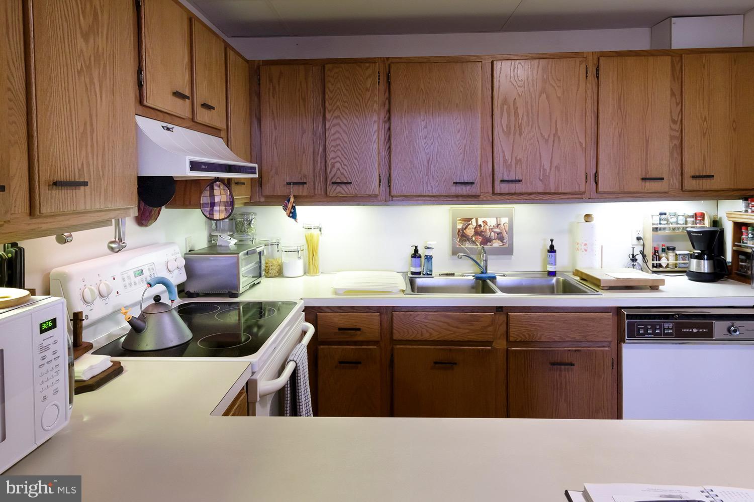 1 Markham Road, Unit 2B Princeton, NJ 08540 - Photo 11 of 19 a kitchen with stainless steel appliances granite countertop a sink stove and cabinets
