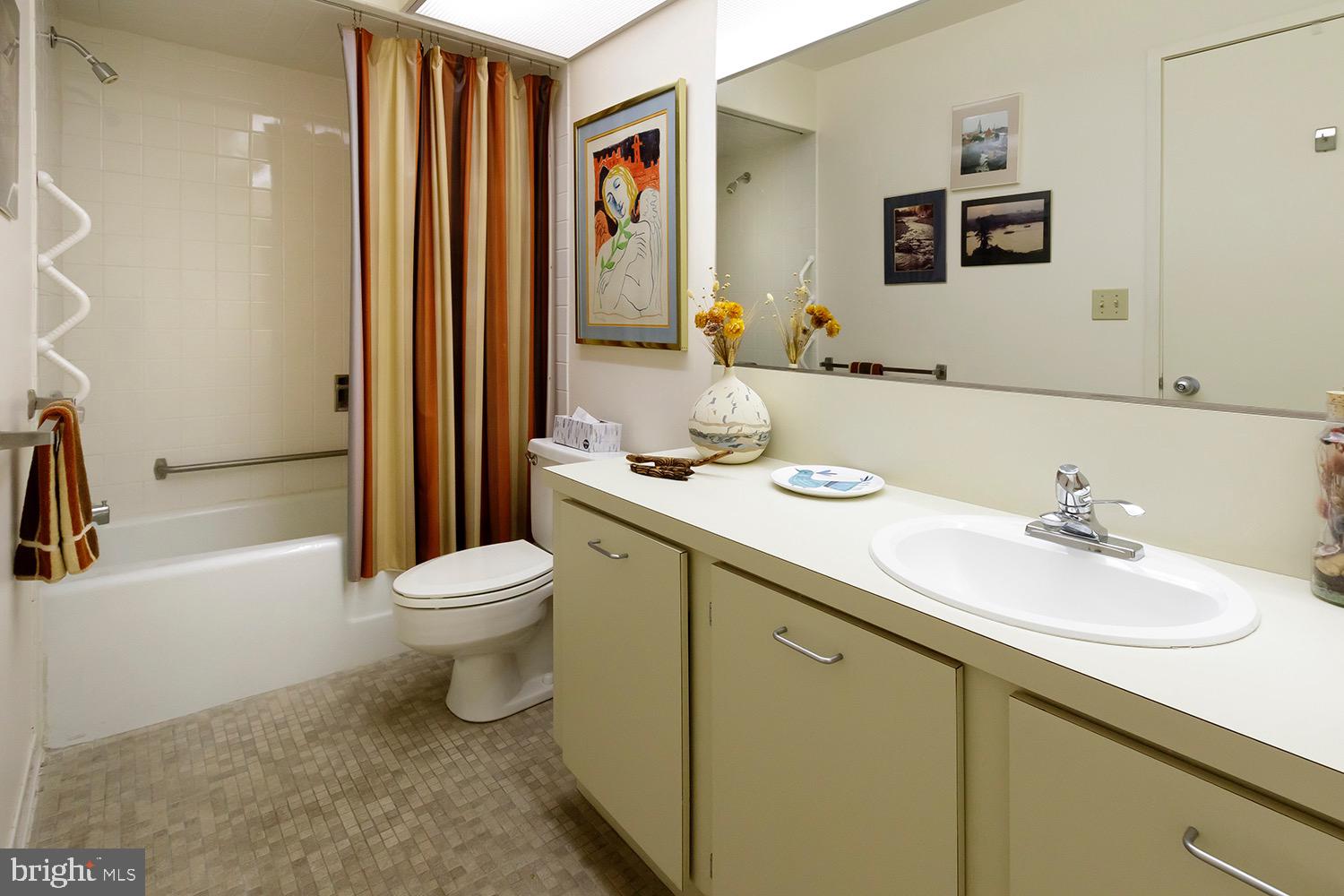 1 Markham Road, Unit 2B Princeton, NJ 08540 - Photo 17 of 19 a bathroom with a granite countertop sink mirror vanity and toilet