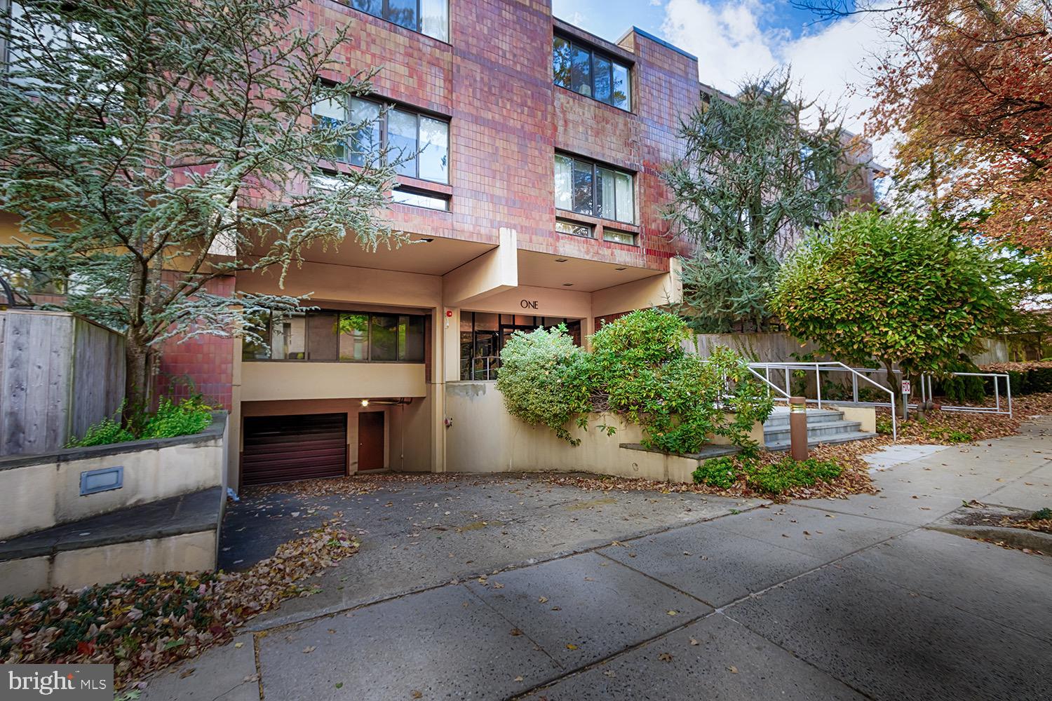 1 Markham Road, Unit 2B Princeton, NJ 08540 - Photo 2 of 19 a front view of a house with a yard and outdoor seating