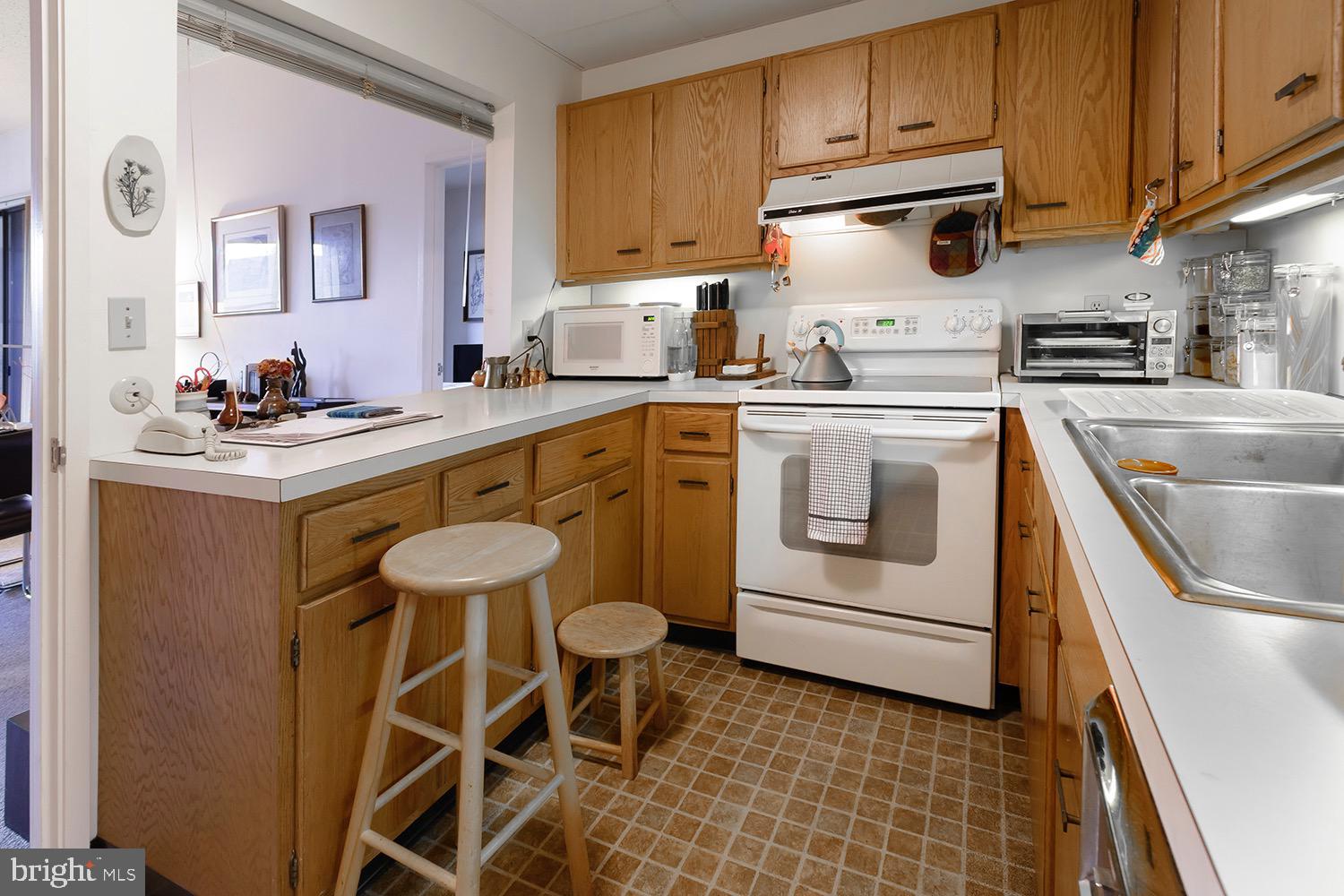 1 Markham Road, Unit 2B Princeton, NJ 08540 - Photo 10 of 19 a kitchen with stainless steel appliances granite countertop a sink stove and cabinets