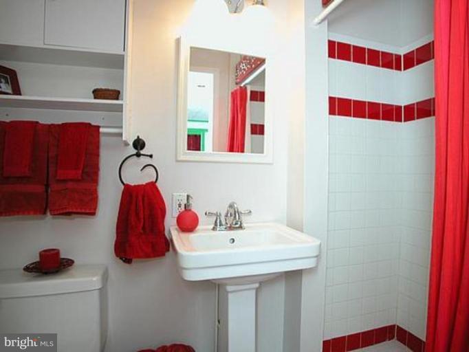1100 Overbrook Road Baltimore, MD 21239 - Photo 12 of 23 a bathroom with a sink and a mirror