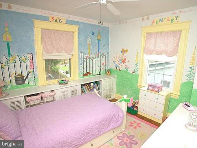 1100 Overbrook Road Baltimore, MD 21239 - Photo 16 of 23 a bedroom with a bed table closet and a window