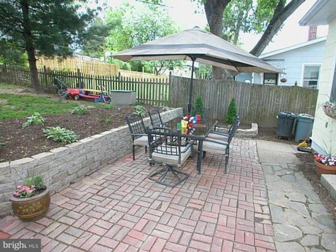 1100 Overbrook Road Baltimore, MD 21239 - Photo 20 of 23 a view of a chairs and table in the back yard of the house