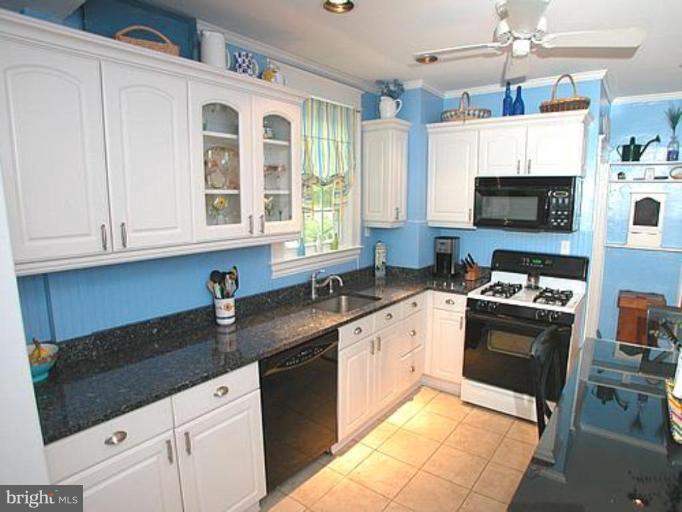 1100 Overbrook Road Baltimore, MD 21239 - Photo 7 of 23 a kitchen with stainless steel appliances granite countertop a stove a sink and a microwave