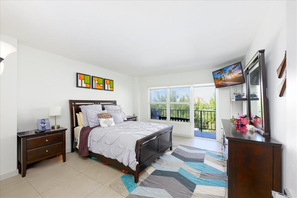 405 North Ocean Boulevard, Unit 611 Pompano Beach, FL 33062 - Photo 11 of 39 a bedroom with a bed and a large window