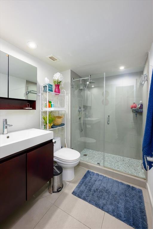 405 North Ocean Boulevard, Unit 611 Pompano Beach, FL 33062 - Photo 12 of 39 a bathroom with a sink a toilet and shower