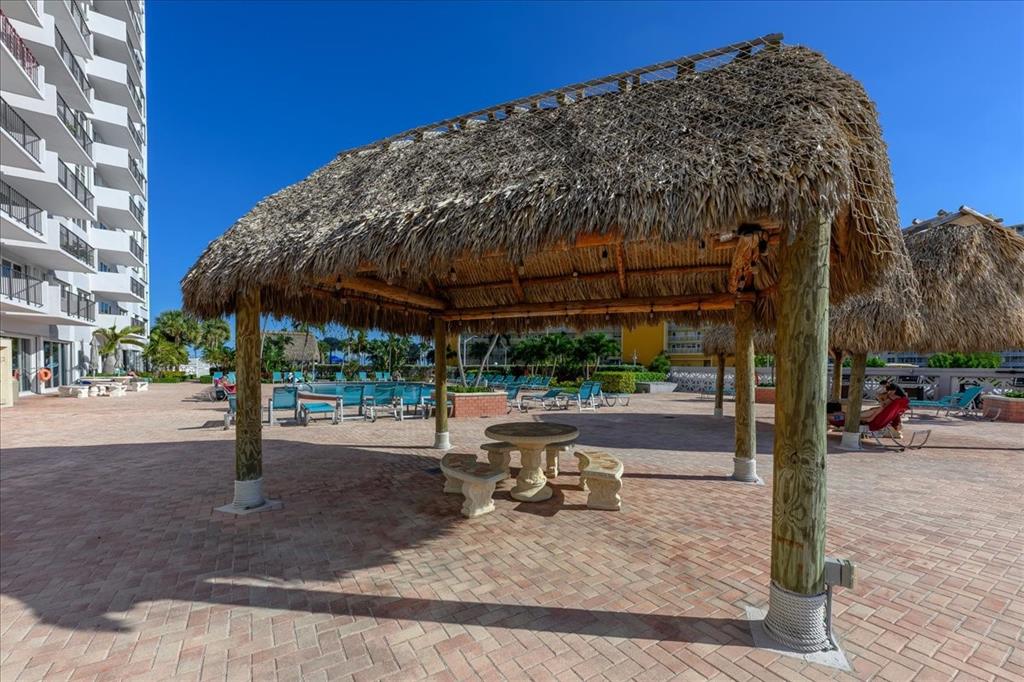 405 North Ocean Boulevard, Unit 611 Pompano Beach, FL 33062 - Photo 14 of 39 a view of a patio with a table and chairs under an umbrella with wooden fence