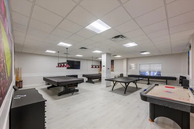 a living room with furniture a wooden floor and next to a window