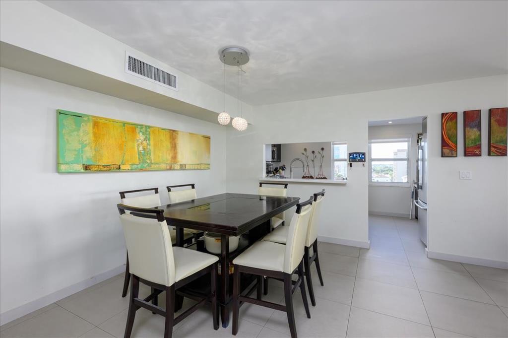 405 North Ocean Boulevard, Unit 611 Pompano Beach, FL 33062 - Photo 21 of 39 a view of a dining room with furniture and wooden floor