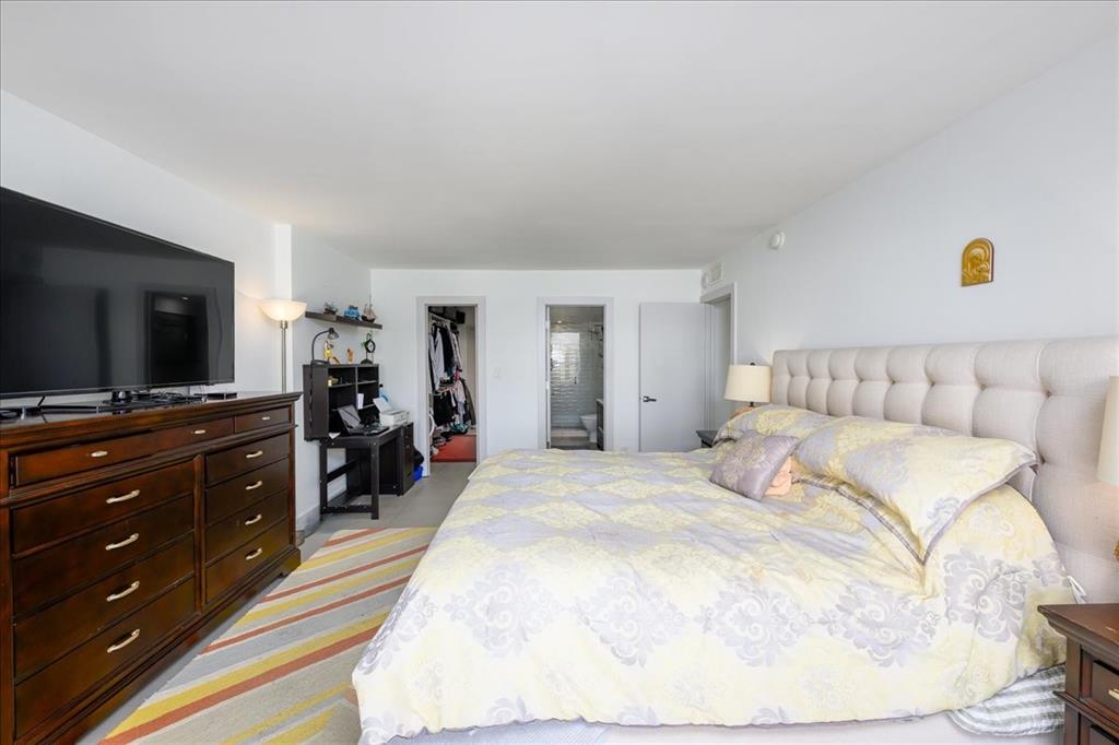 405 North Ocean Boulevard, Unit 611 Pompano Beach, FL 33062 - Photo 8 of 39 a bedroom with a bed and a flat screen tv