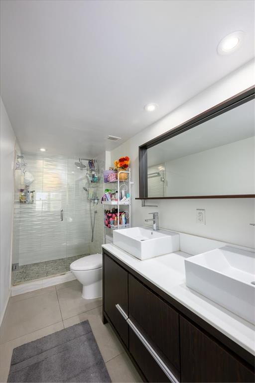 405 North Ocean Boulevard, Unit 611 Pompano Beach, FL 33062 - Photo 9 of 39 a bathroom with a sink toilet and shower