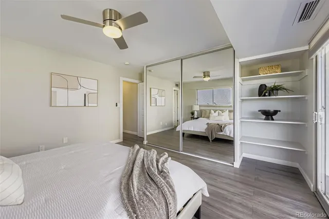 a bedroom with a bed and a view of closet