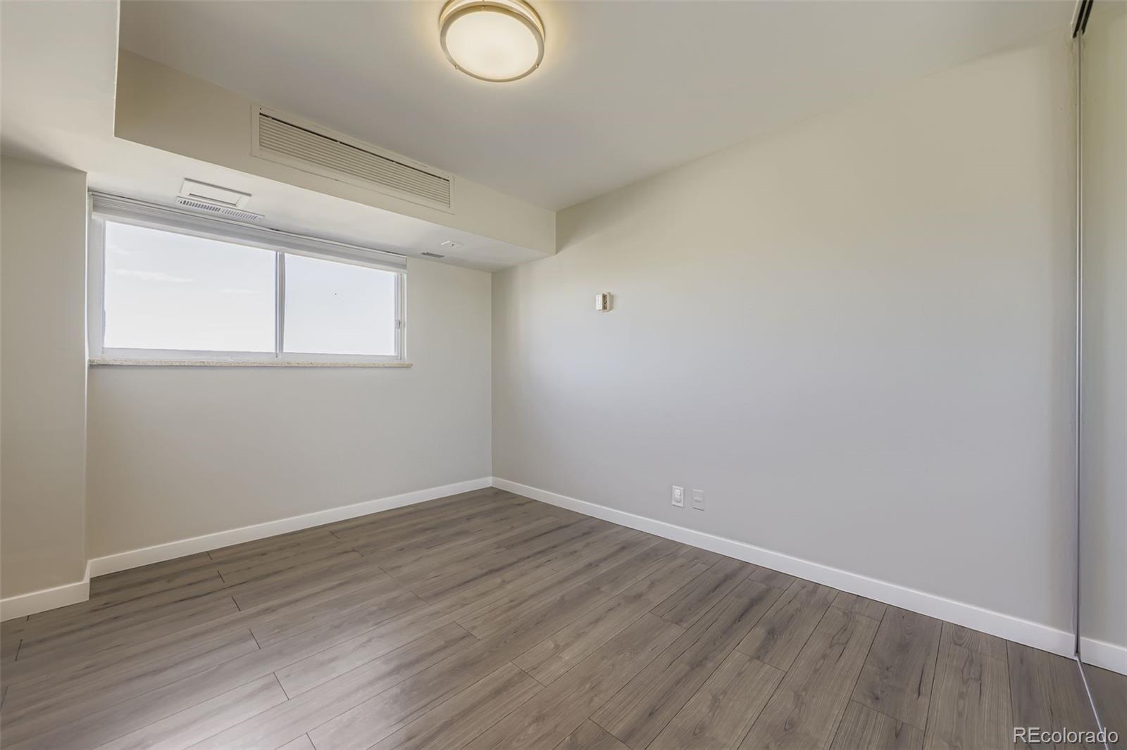 1121 Albion Street, Unit 709 Denver, CO 80220 - Photo 14 of 24 a view of a room that has wooden floor and window
