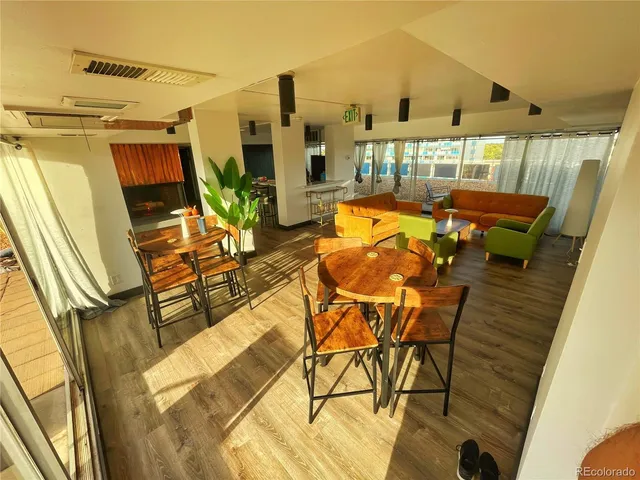 a living room with a fireplace a flat screen tv and a large window