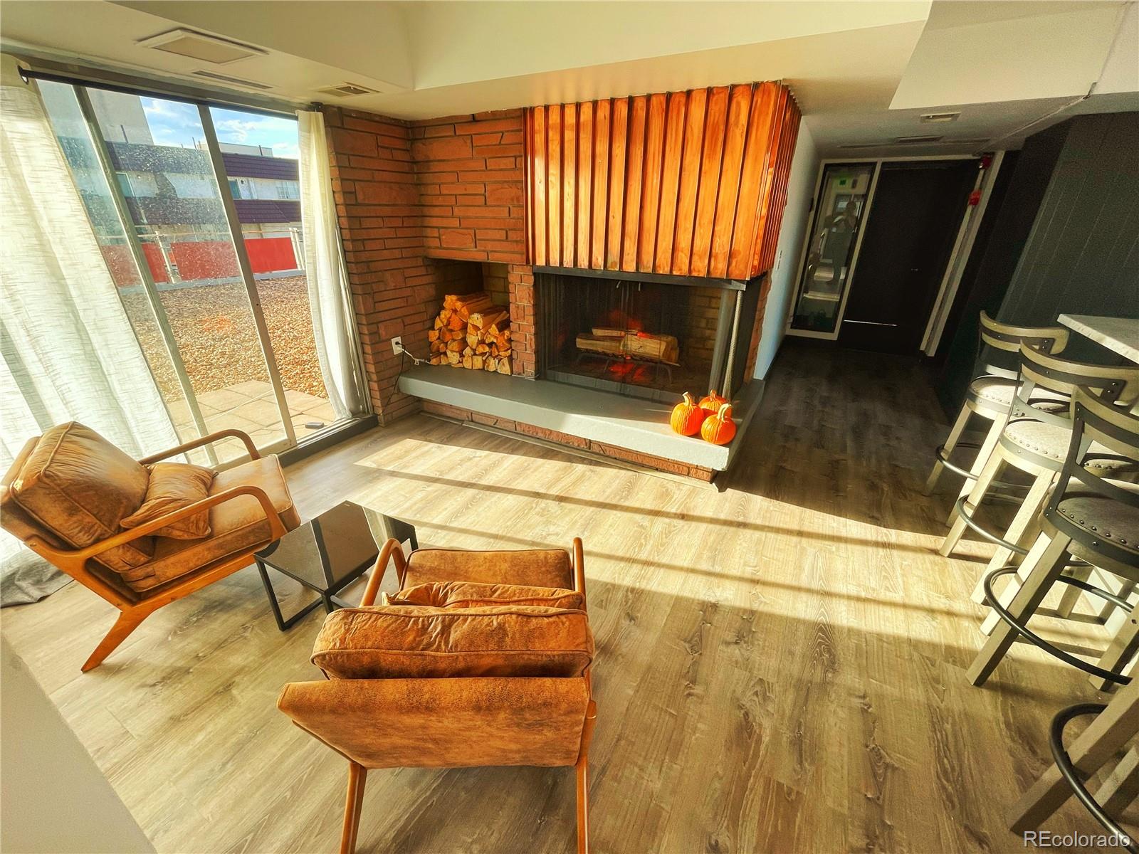 1121 Albion Street, Unit 709 Denver, CO 80220 - Photo 23 of 24 a living room with a fireplace a flat screen tv and a large window