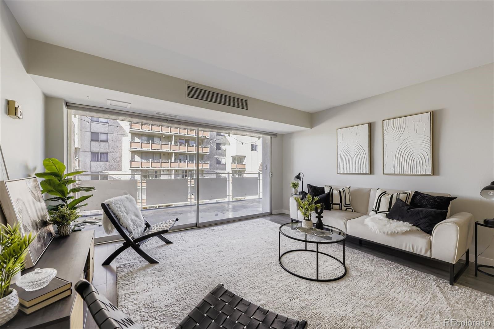 1121 Albion Street, Unit 709 Denver, CO 80220 - Photo 3 of 24 a living room with furniture a window and potted plants