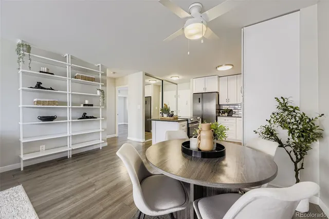 a kitchen with stainless steel appliances a dining table chairs and chandelier