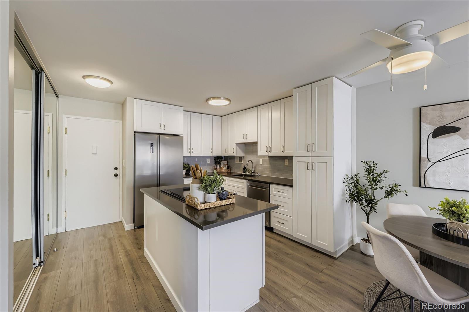 1121 Albion Street, Unit 709 Denver, CO 80220 - Photo 5 of 24 a kitchen with refrigerator a table and chairs