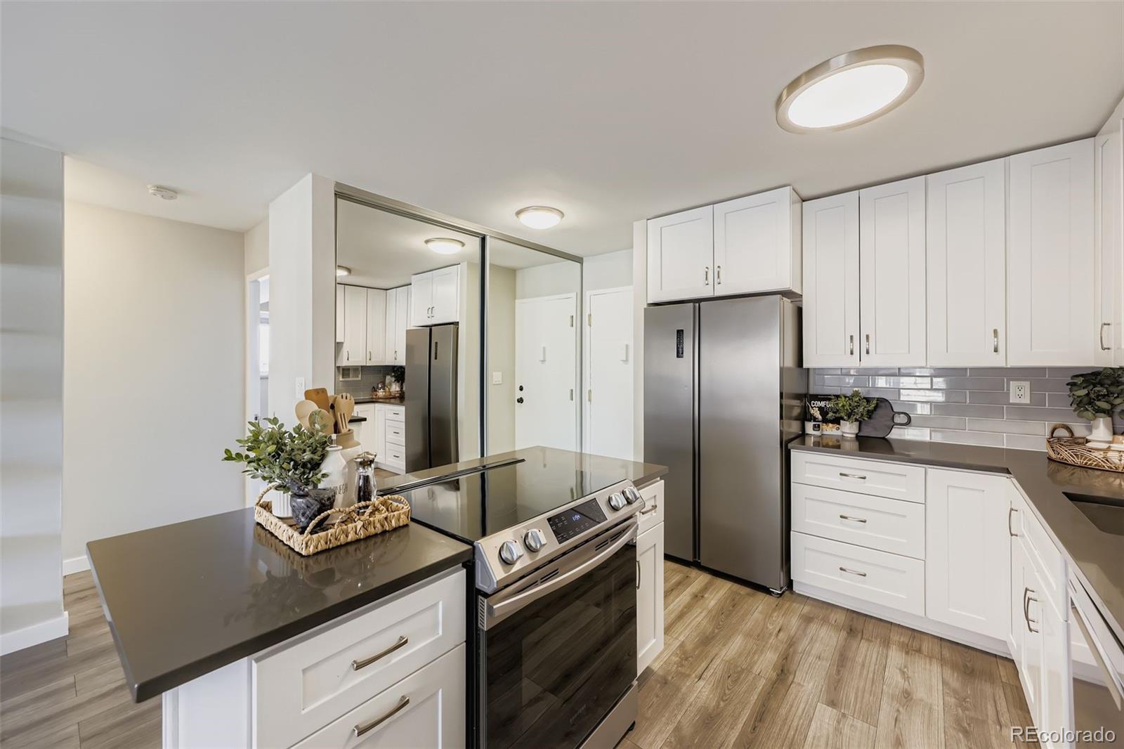 1121 Albion Street, Unit 709 Denver, CO 80220 - Photo 7 of 24 a kitchen with stainless steel appliances granite countertop a refrigerator and a sink