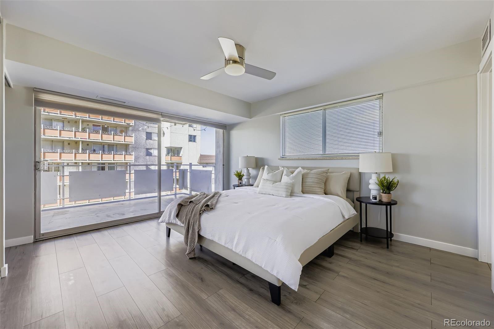 1121 Albion Street, Unit 709 Denver, CO 80220 - Photo 9 of 24 a bedroom with a bed and large window with wooden floor